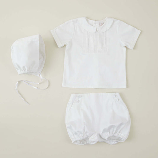 Vista frontal de pelele blanco para bautizo con botones perlados