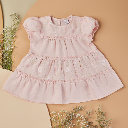 Conjunto infantil de dos piezas en tono beige con bordados delicados.