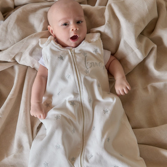 Detalle del estampado de estrellas y luna en saco de dormir para bebé.